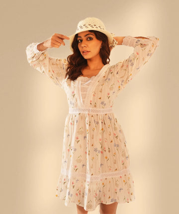 Woman in a white floral cottagecore dress with lace details and a crochet hat – Drape Panda Cottagecore Collection
