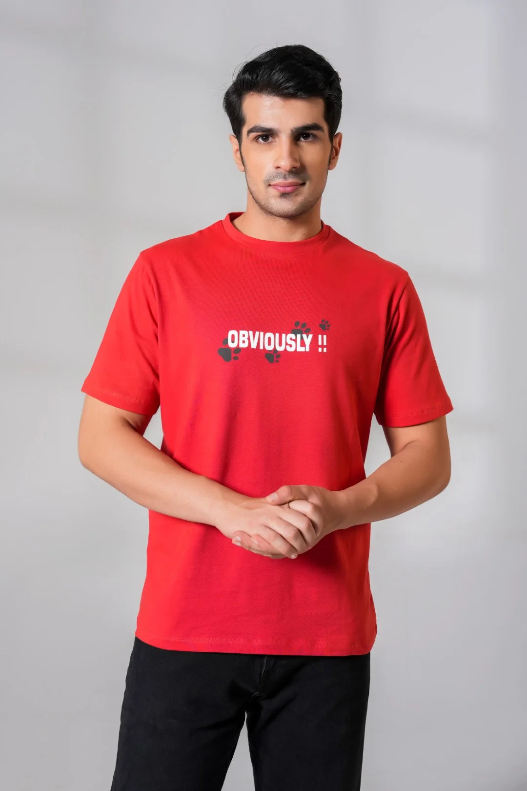 Man wearing a red cotton t-shirt with "Obviously!!" slogan and paw prints in HD print across the chest, styled casually