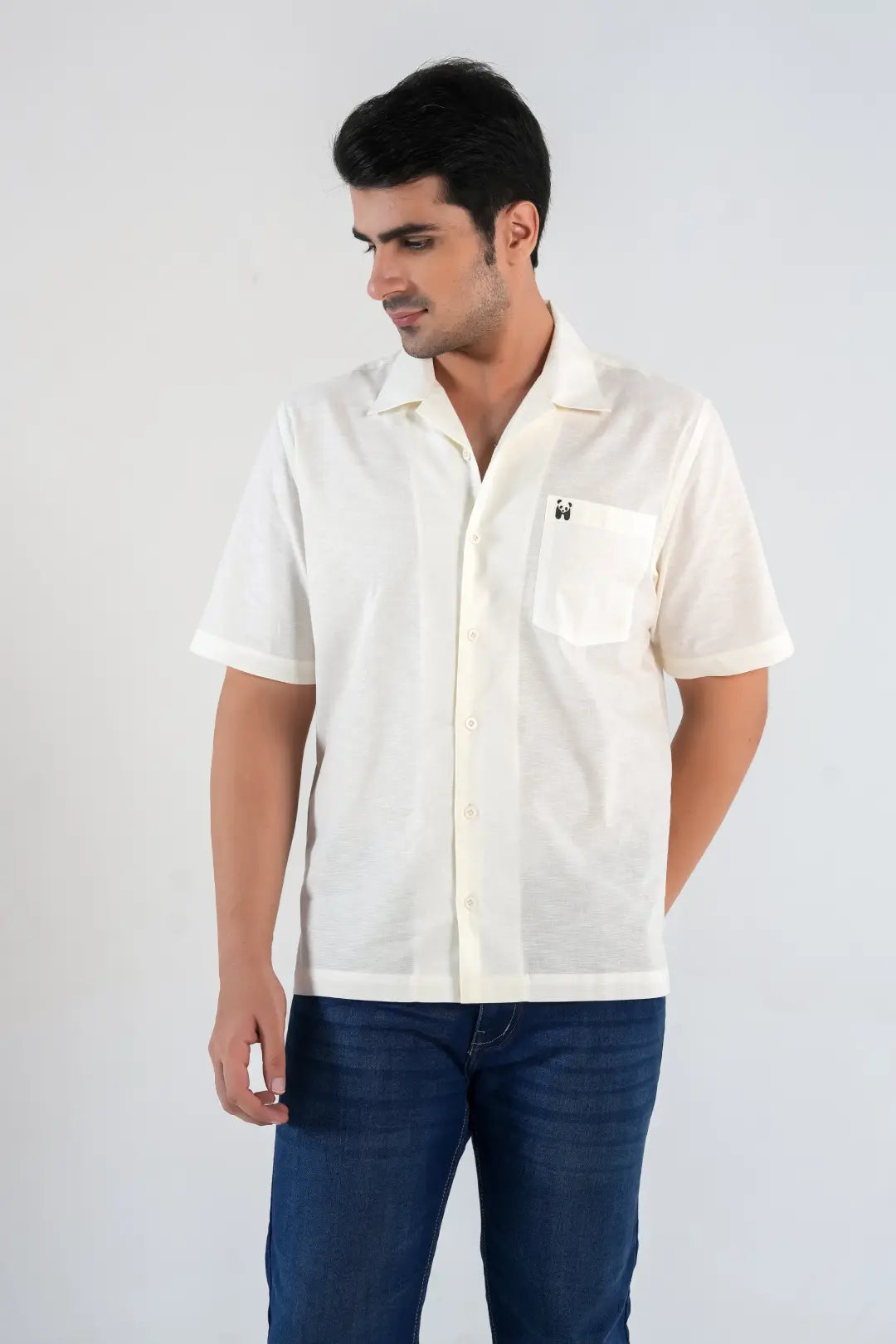 Front view of men’s off-white camp collar shirt with blue jeans, relaxed summer fit