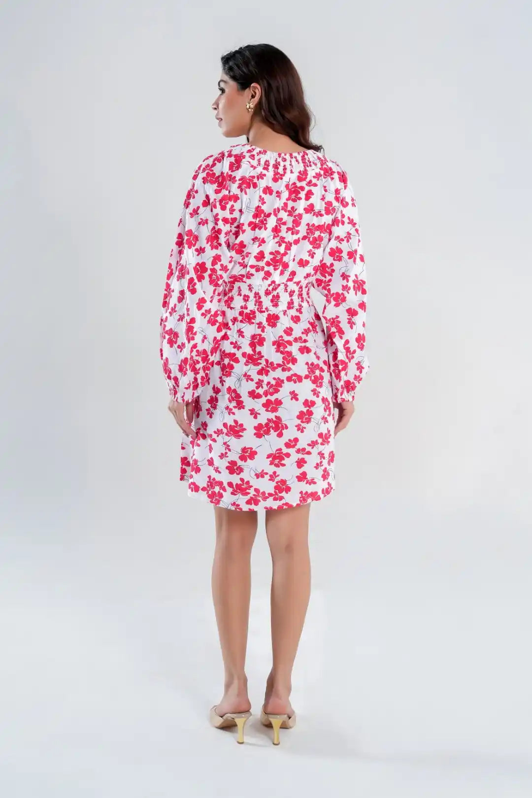 Back view of women’s white cotton sundress with red floral print, showcasing airy relaxed fit above knee length.