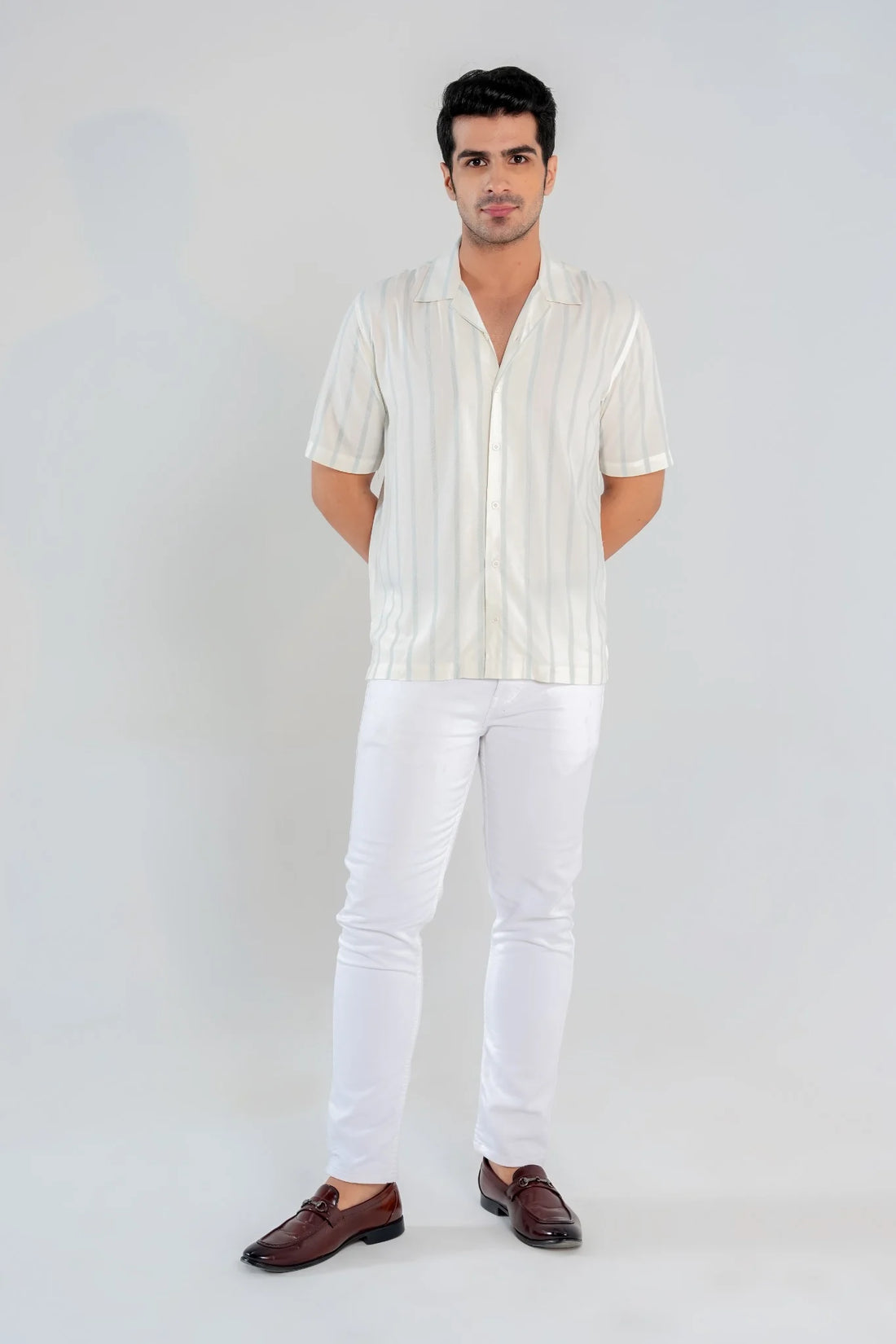 Front view of men’s short sleeve white and blue striped cotton shirt with Cuban collar